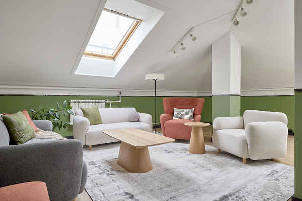 Bright office with skylight, modern chairs and sofas